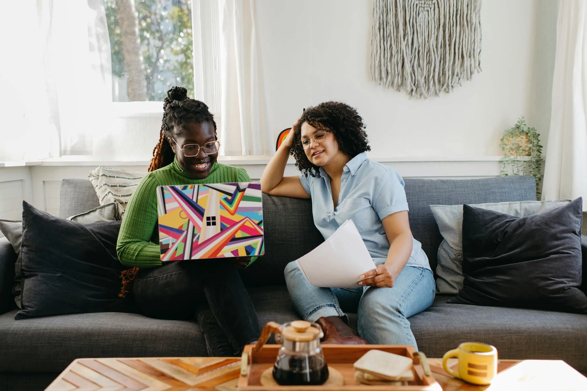 women sitting on couch